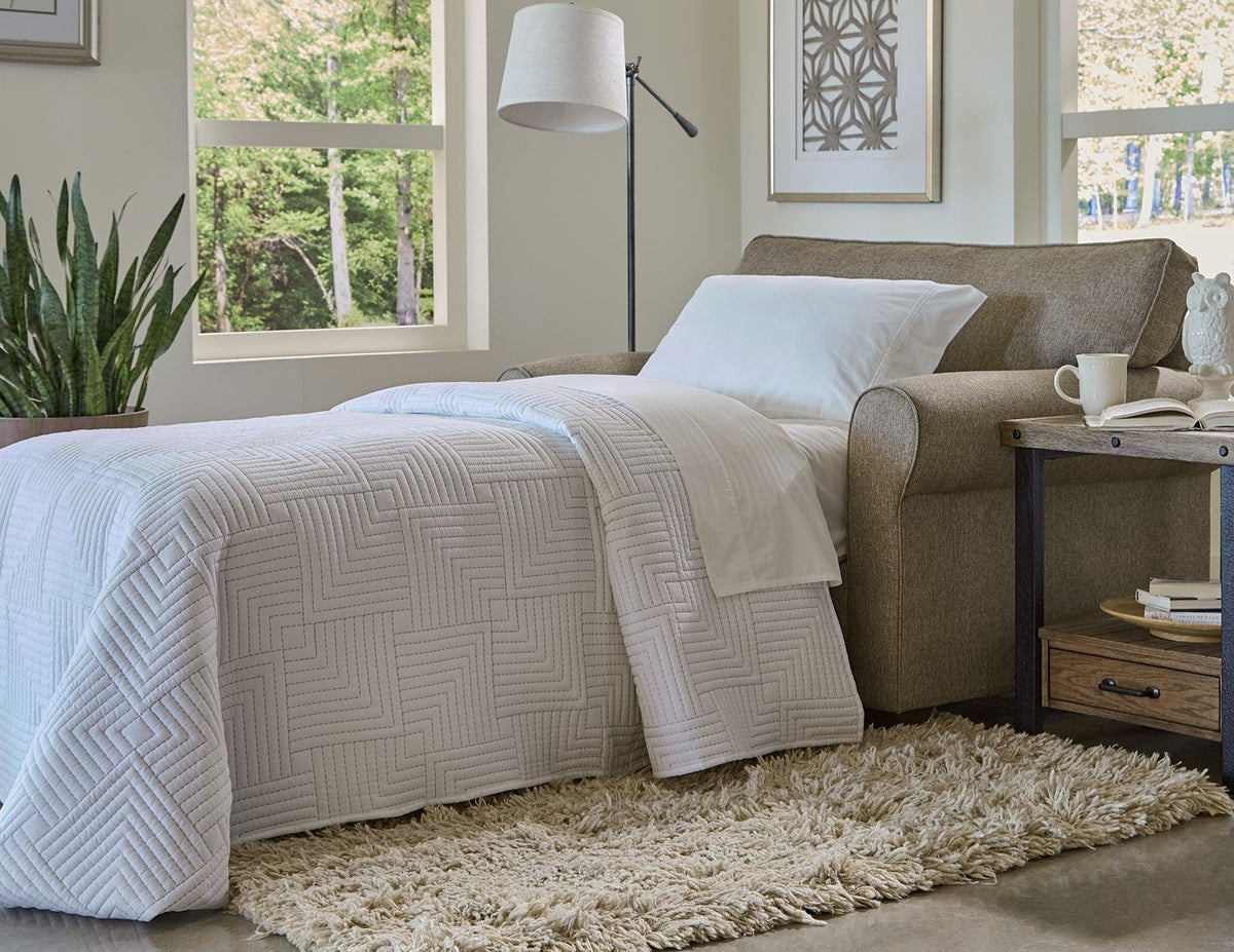 England Seabury sleeper sofa opened into a made-up bed in a living room, Kensington Furniture, Northfield NJ