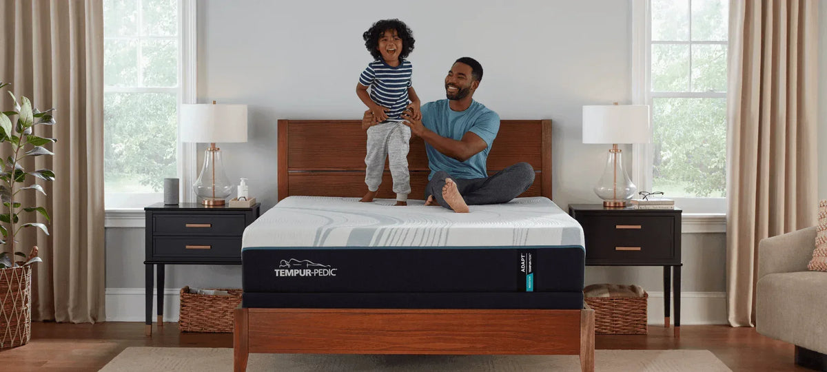 Father and child on a TEMPUR-Adapt mattress in a bedroom, Kensington Furniture, Northfield NJ